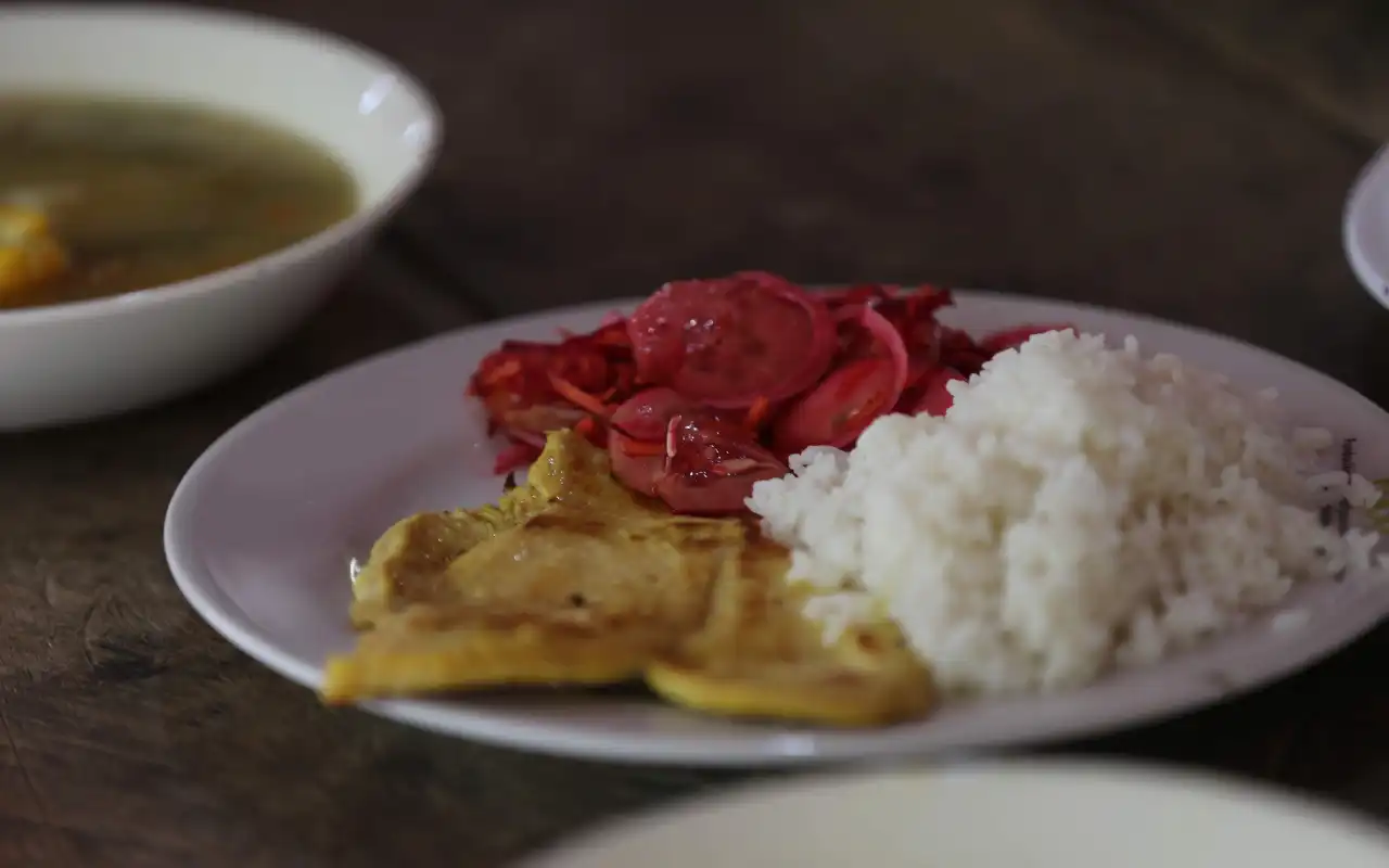 Traditional Colombian breakfast served at camp: arepas, eggs, fruit, and coffee.